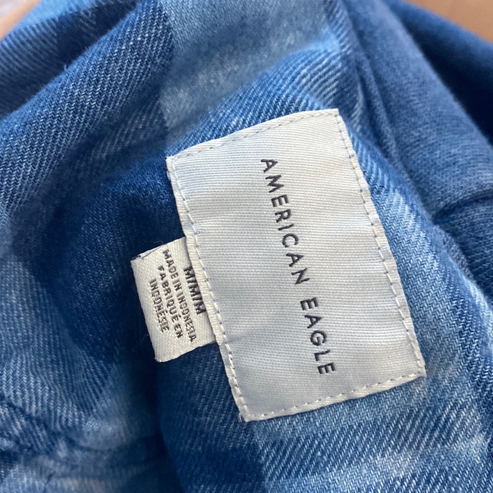 Women’s blue plaid hoodie with rips in the elbows